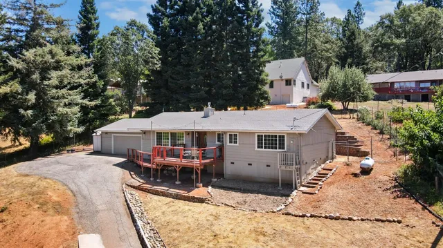 an aerial view of a house with a yard patio and tree s