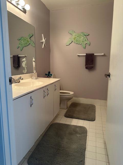 8025 Whispering Palm Drive Boca Raton, FL 33496 - Photo 15 of 27 a bathroom with a toilet sink and mirror