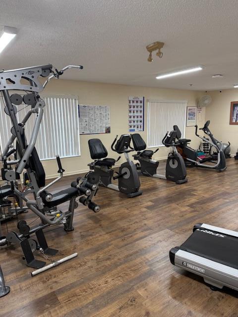 8025 Whispering Palm Drive Boca Raton, FL 33496 - Photo 25 of 27 a living room with furniture gym equipment and a view of bedroom