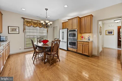 a view of a dining room with furniture and chandelier