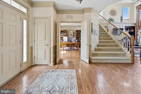 a view of a hallway view with wooden floor and staircase