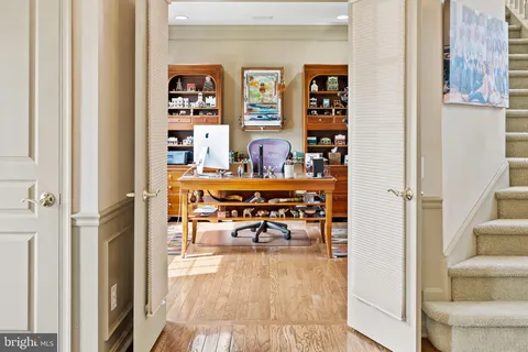 a living room with furniture and a book shelf