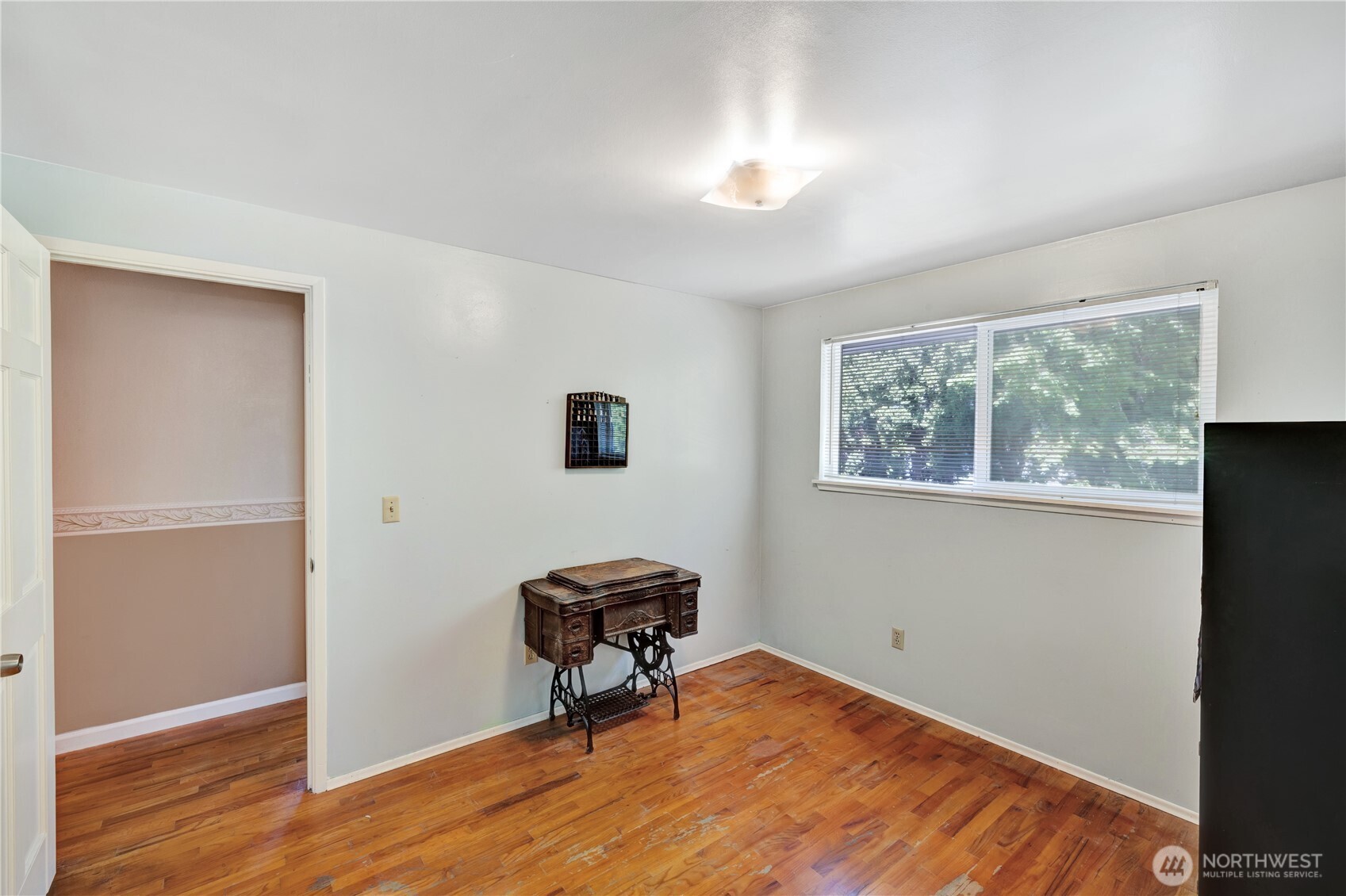 10208 28th Avenue Southwest Seattle, WA 98146 - Photo 12 of 17 a view of room with wooden floor and a window