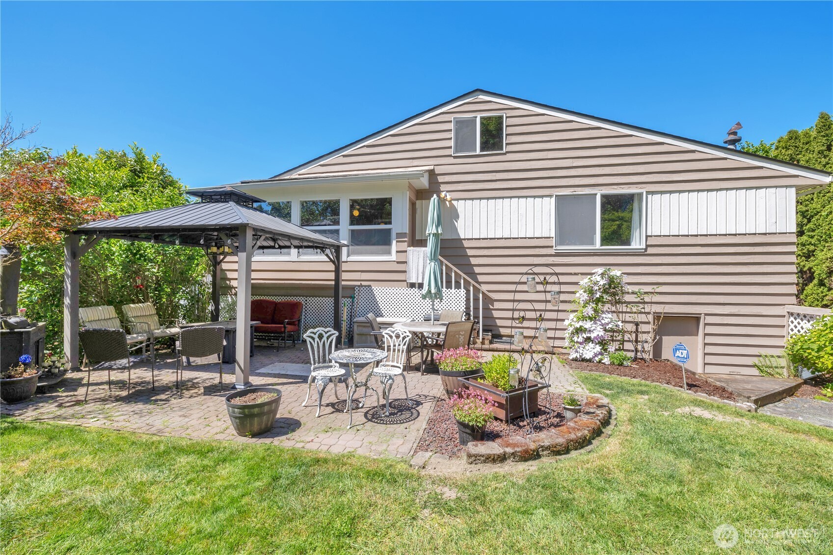 10208 28th Avenue Southwest Seattle, WA 98146 - Photo 15 of 17 a front view of house with a garden and patio