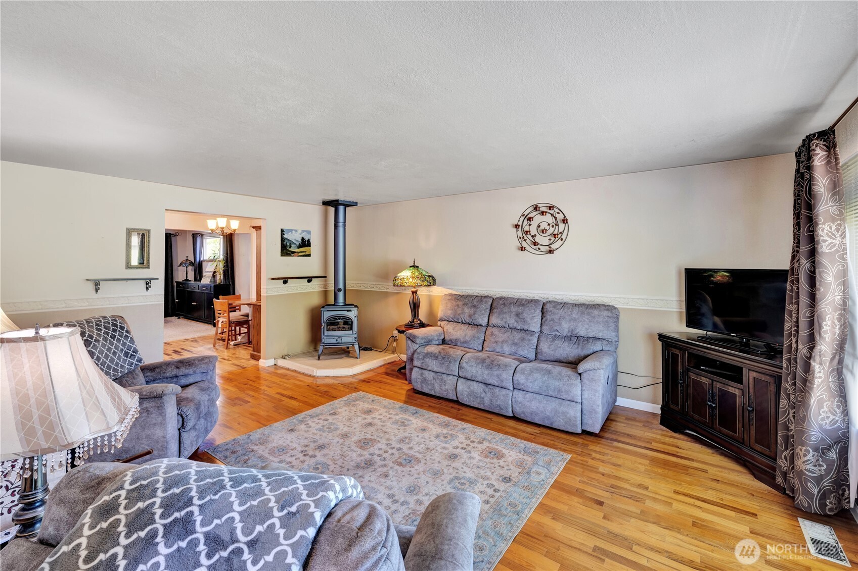 10208 28th Avenue Southwest Seattle, WA 98146 - Photo 3 of 17 a living room with furniture and a flat screen tv