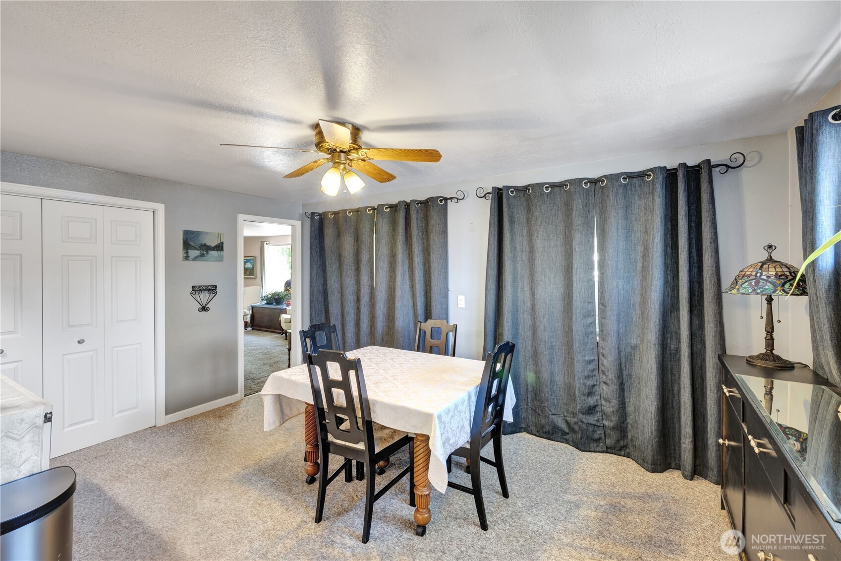 10208 28th Avenue Southwest Seattle, WA 98146 - Photo 6 of 17 a view of a dining room with furniture and chandelier