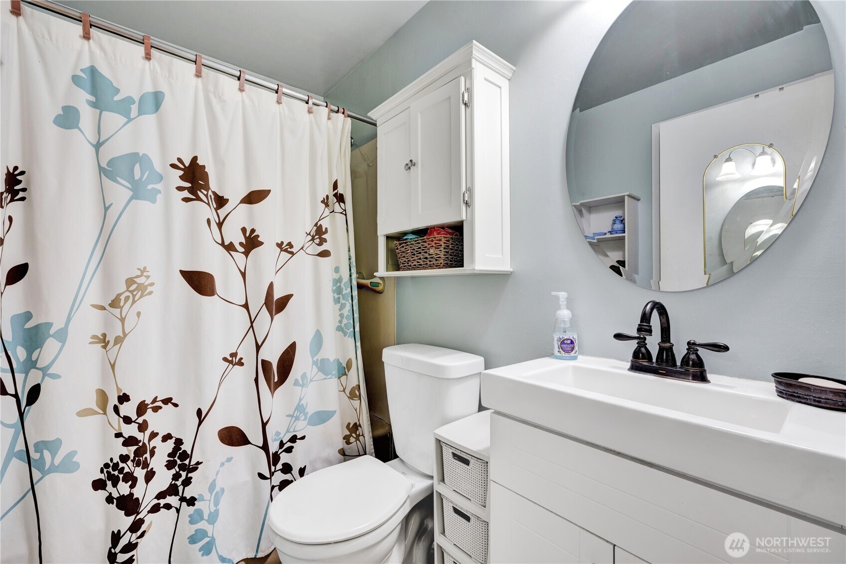 10208 28th Avenue Southwest Seattle, WA 98146 - Photo 9 of 17 a bathroom with a toilet sink and mirror