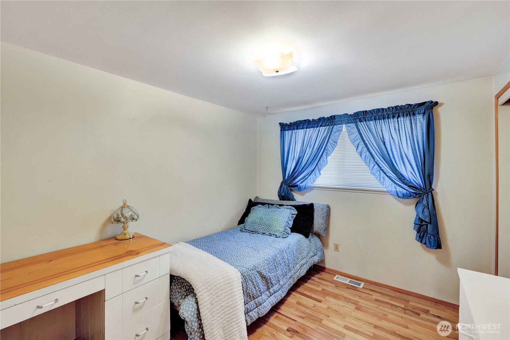 10208 28th Avenue Southwest Seattle, WA 98146 - Photo 10 of 17 a bedroom with a bed and a window