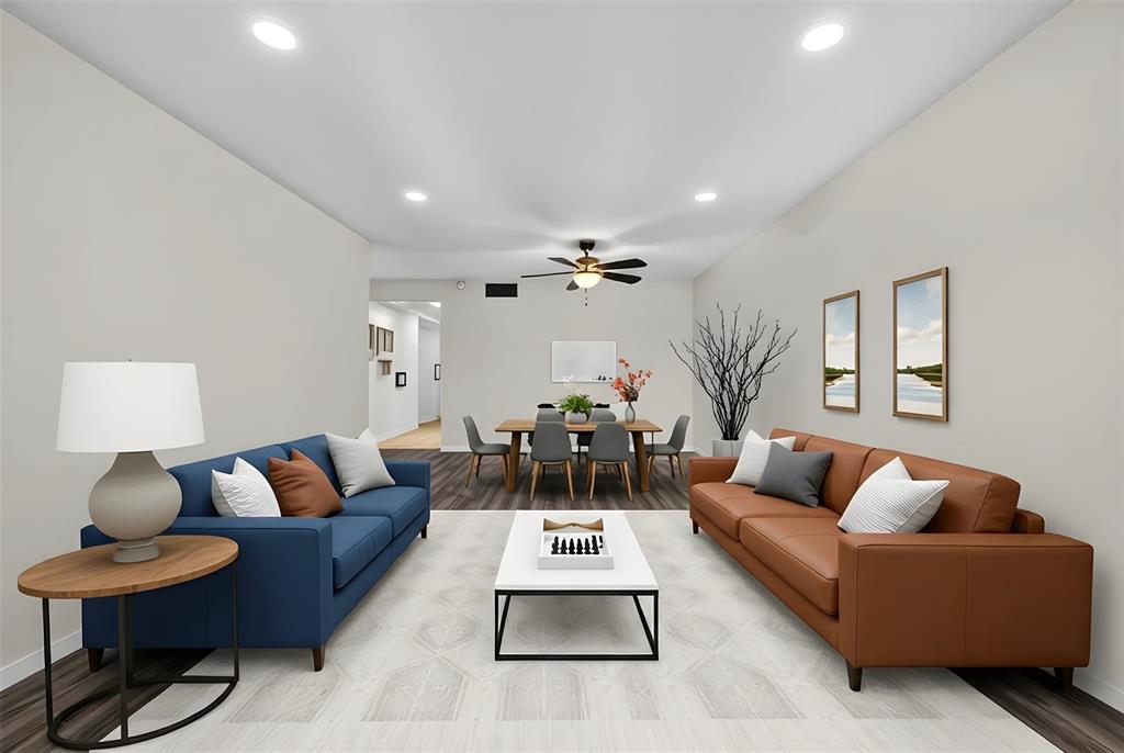 a living room with furniture a rug and a chandelier