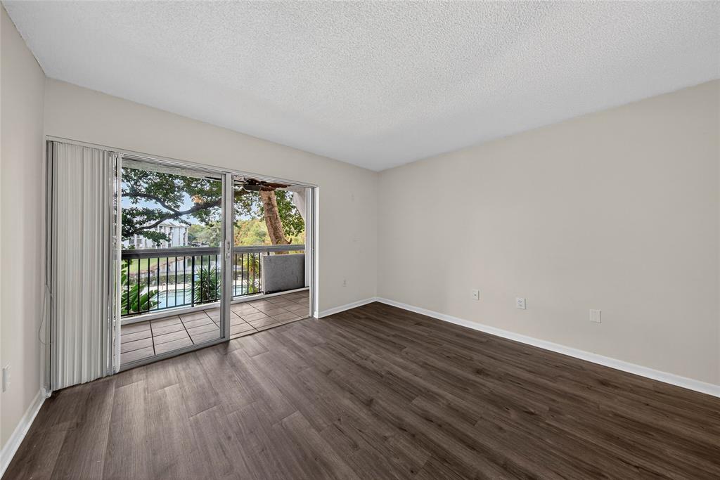 711 North Pine Island Road, Unit 319 Plantation, FL 33324 - Photo 4 of 27 wooden floor in an empty room with a window