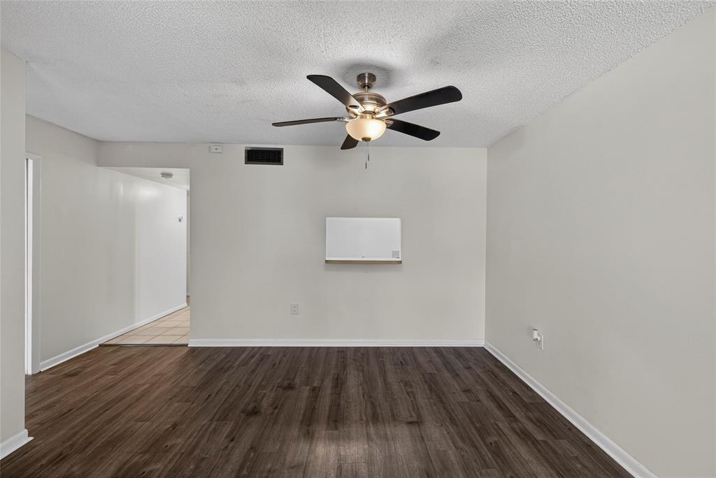 711 North Pine Island Road, Unit 319 Plantation, FL 33324 - Photo 7 of 27 an empty room with wooden floor and a ceiling fan