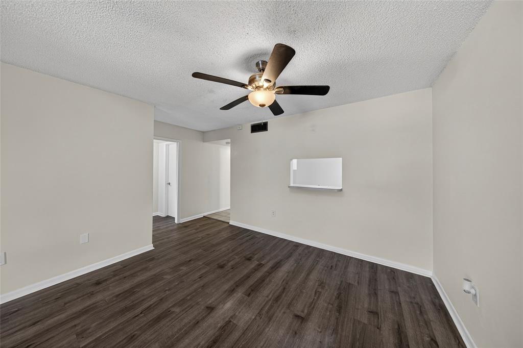 711 North Pine Island Road, Unit 319 Plantation, FL 33324 - Photo 8 of 27 a view of an empty room with window and wooden floor