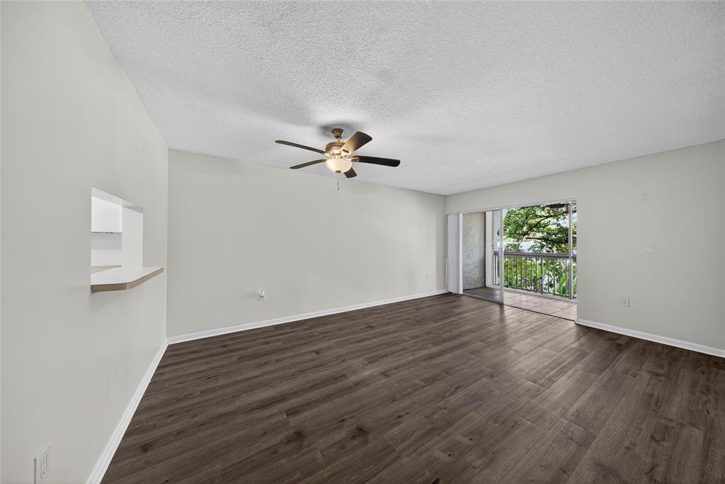 711 North Pine Island Road, Unit 319 Plantation, FL 33324 - Photo 9 of 27 a view of a livingroom with wooden floor and a ceiling fan
