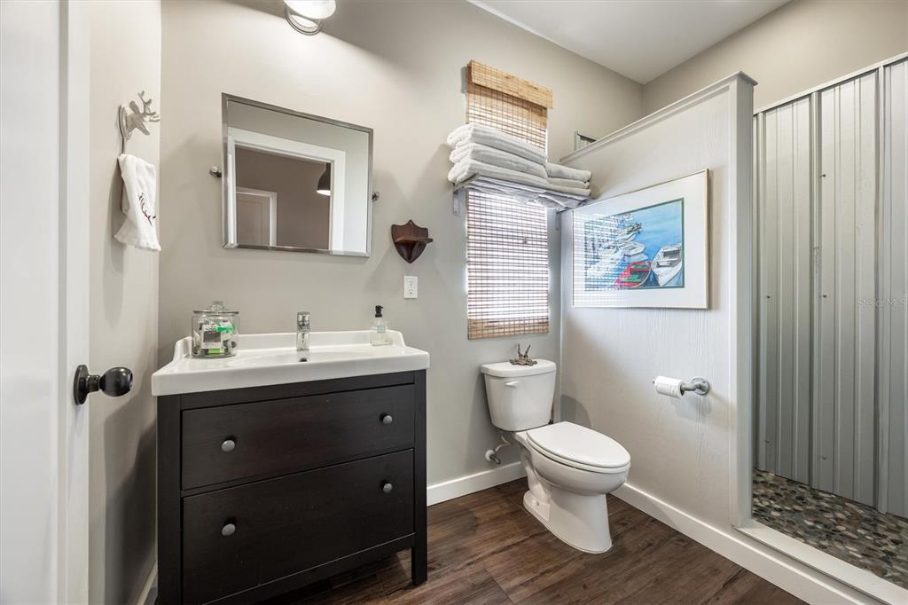 1412 Baden Powell Road Hawthorne, FL 32640 - Photo 20 of 48 a bathroom with a toilet sink and mirror