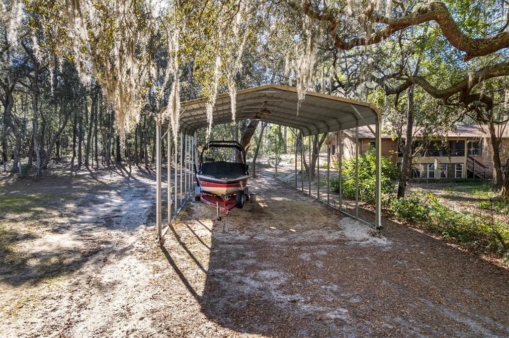 1412 Baden Powell Road Hawthorne, FL 32640 - Photo 34 of 48 a view of a backyard with table and chairs under an umbrella