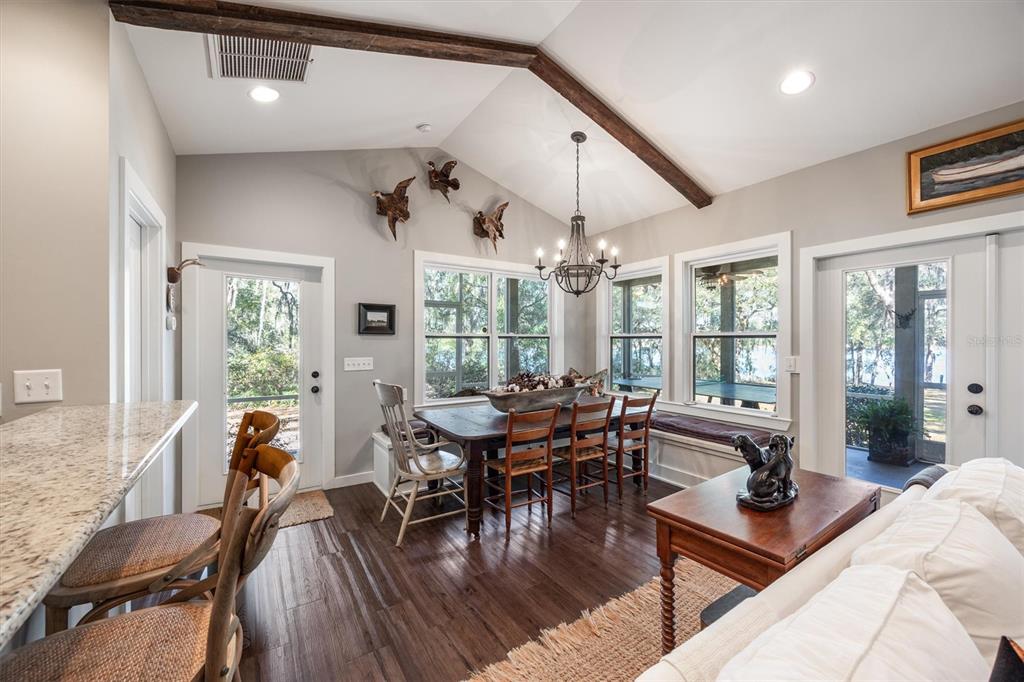 1412 Baden Powell Road Hawthorne, FL 32640 - Photo 4 of 48 a living room with furniture a wooden floor and floor to ceiling windows