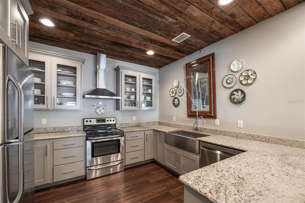 1412 Baden Powell Road Hawthorne, FL 32640 - Photo 9 of 48 a kitchen with stainless steel appliances granite countertop a stove a sink and white cabinets