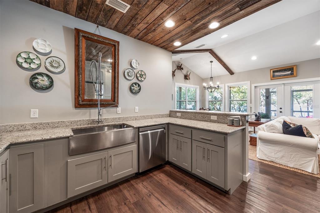 1412 Baden Powell Road Hawthorne, FL 32640 - Photo 10 of 48 a large kitchen with stainless steel appliances granite countertop a sink and wooden cabinets