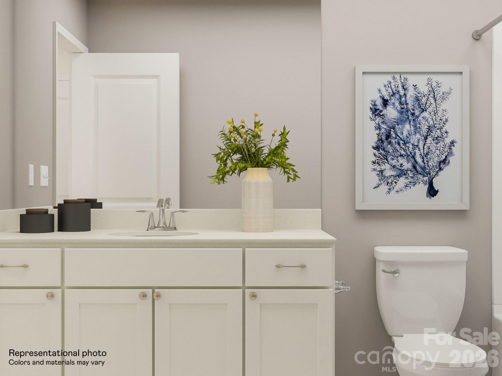 7002 Juneberry Way Maiden, NC 28650 - Photo 7 of 25 a bathroom with a toilet a sink and mirror