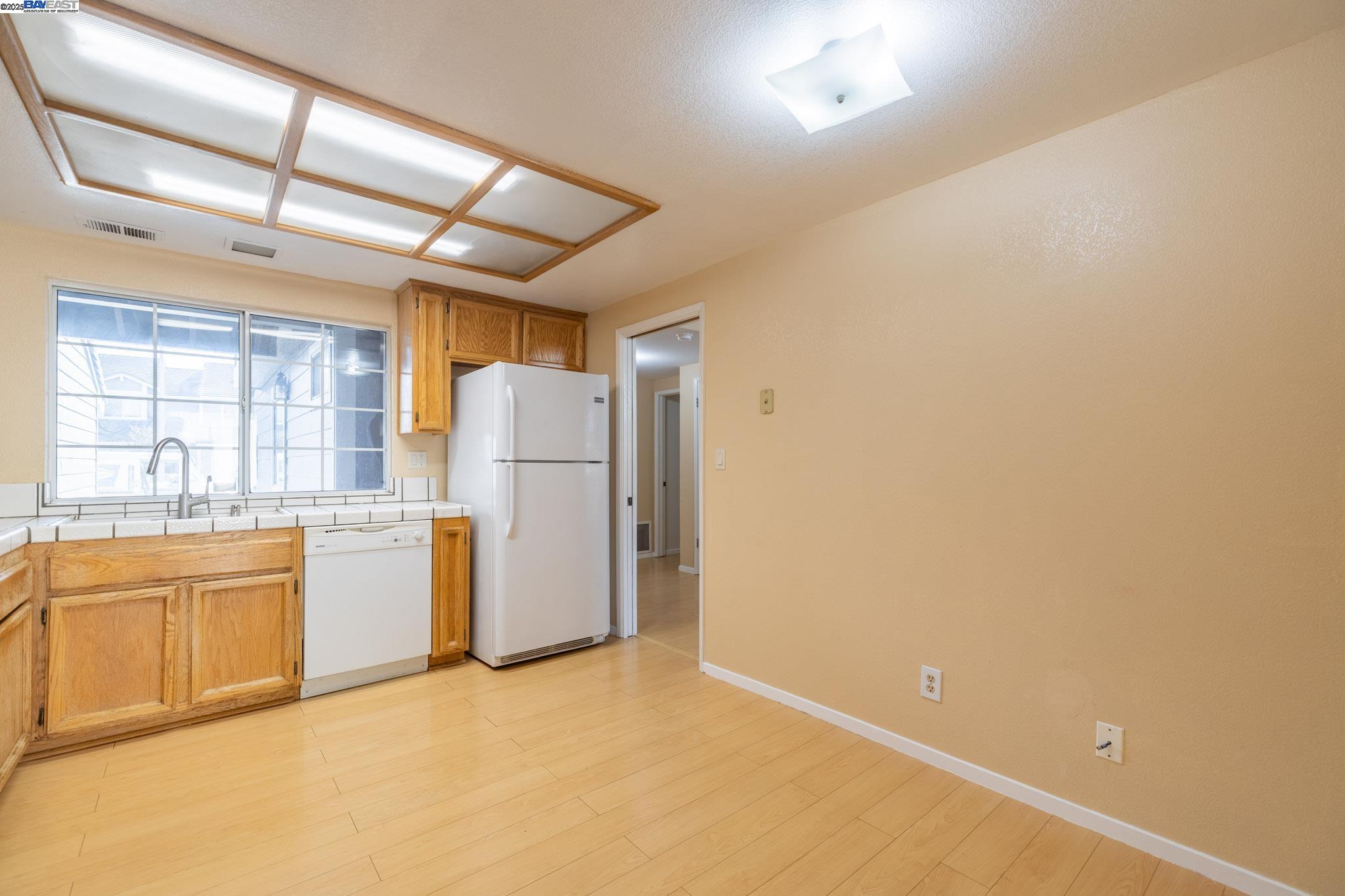 123 Pelican Loop Pittsburg, CA 94565 - Photo 12 of 60 a kitchen with refrigerator and window