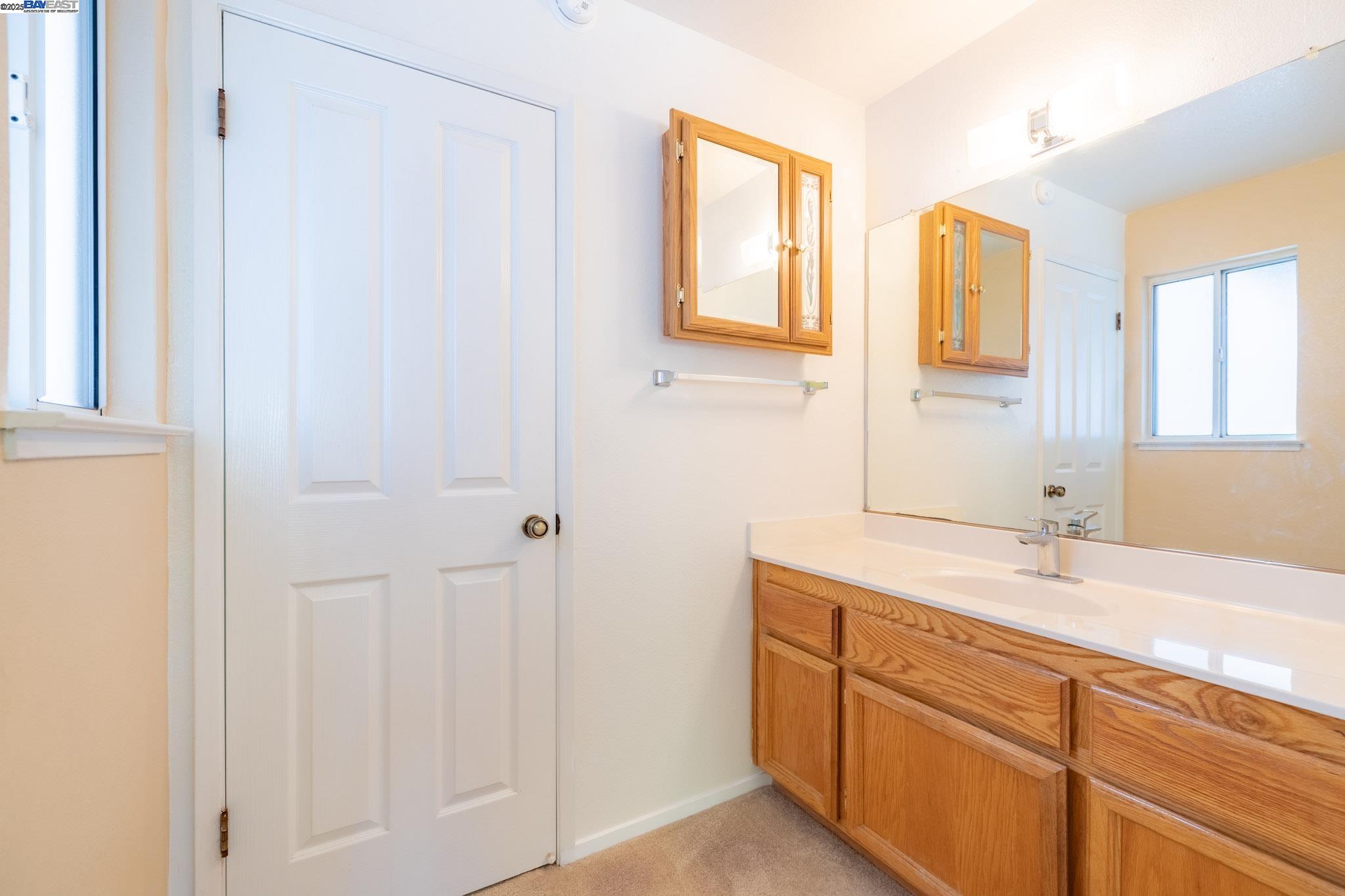 123 Pelican Loop Pittsburg, CA 94565 - Photo 27 of 60 a bathroom with a sink and a mirror