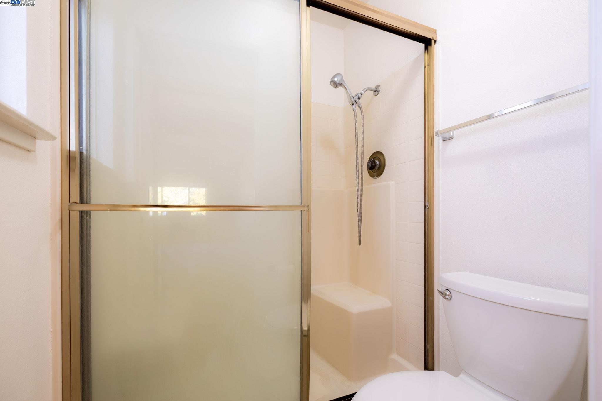 123 Pelican Loop Pittsburg, CA 94565 - Photo 28 of 60 a bathroom with a shower and a toilet