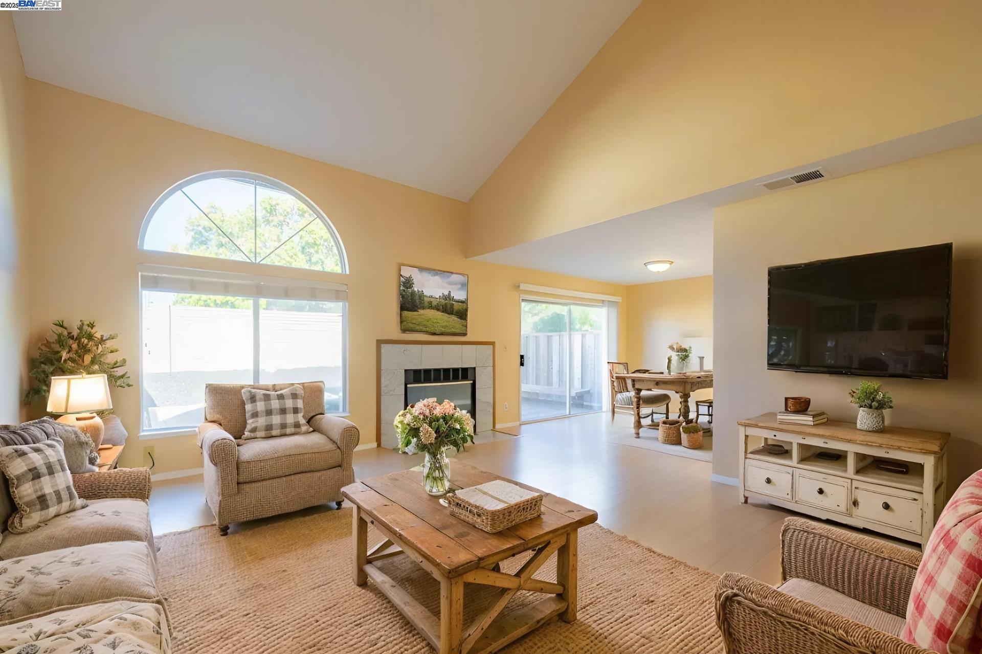 123 Pelican Loop Pittsburg, CA 94565 - Photo 5 of 60 a living room with furniture a flat screen tv and a fireplace