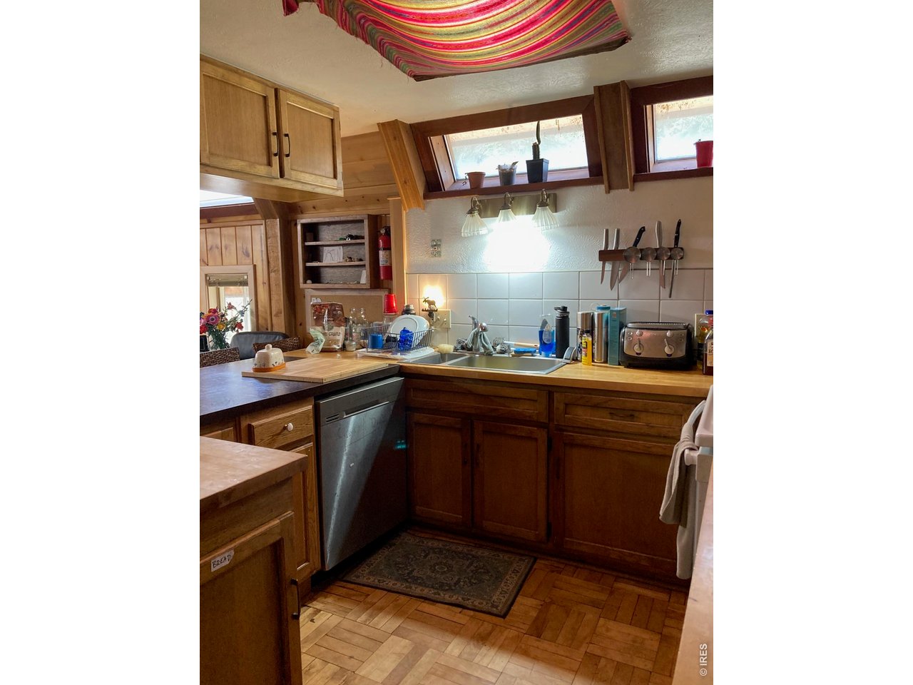 1064 Cold Springs Road Nederland, CO 80466 - Photo 6 of 48 a kitchen with stainless steel appliances a sink and cabinets
