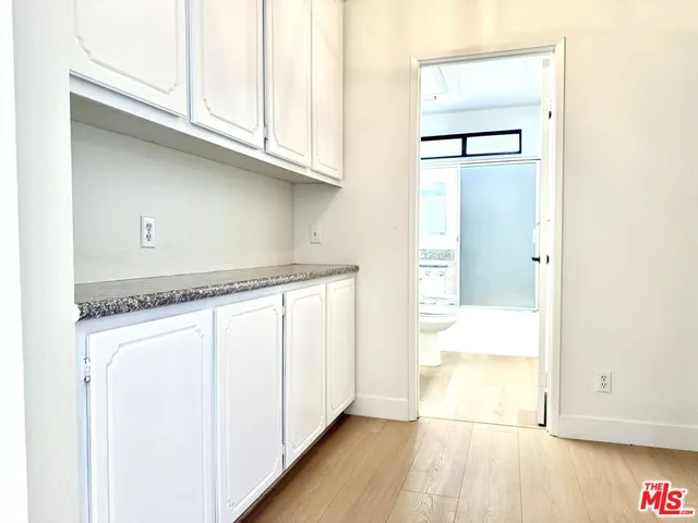 a kitchen with a refrigerator and window