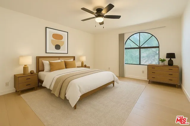 a spacious bedroom with a bed and a painting on the wall