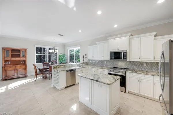 a kitchen with a sink stove and cabinets
