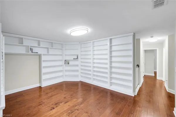 a view of walk in closet with empty racks