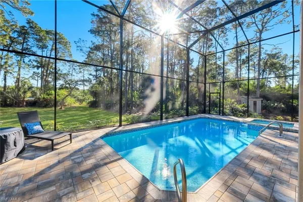 a view of swimming pool with seating space and hardwood floor