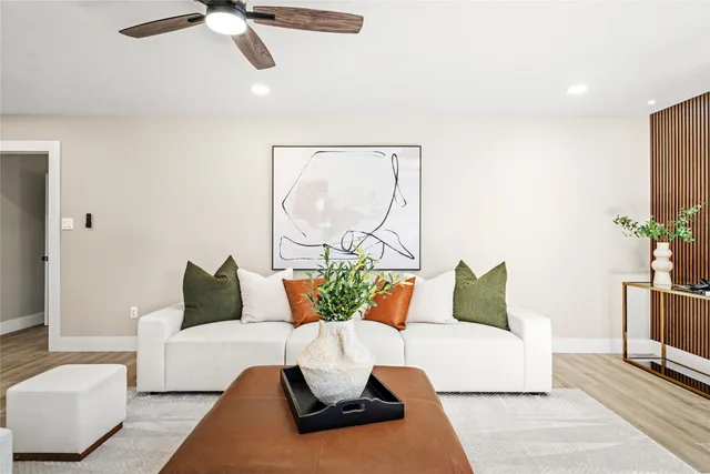a view of a house with a big yard and large trees