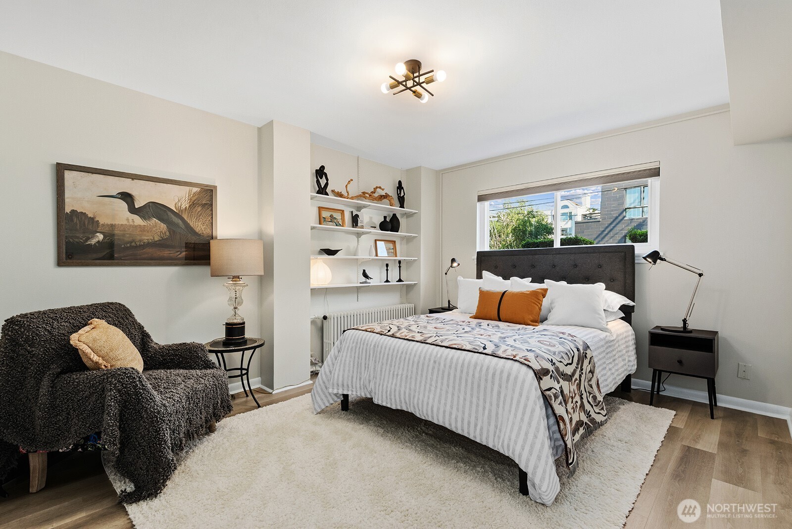 4407 Southwest Alaska Street, Unit 11 Seattle, WA 98116 - Photo 10 of 24 a bedroom with a bed and wooden floor
