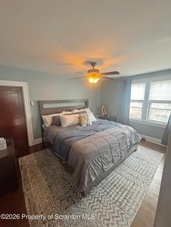 a bedroom with a large bed and a window