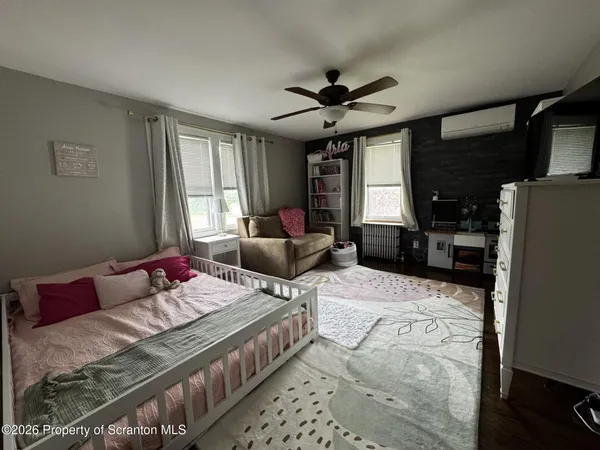 a bedroom with a bed furniture and a window