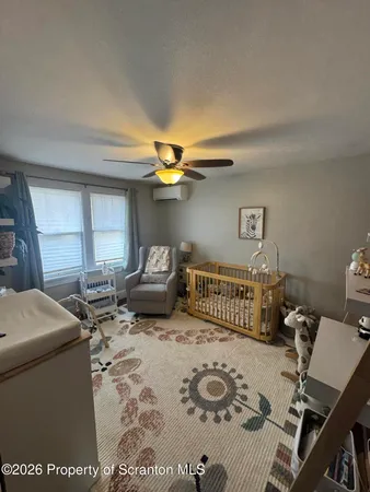 a bedroom with furniture and a window