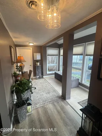 a living room with furniture and a chandelier