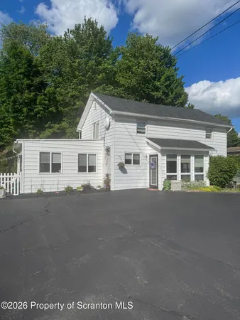 a front view of a house with a garden and porch