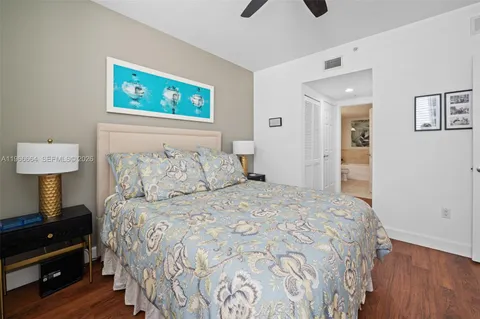 a bedroom with a bed a lamp and a window