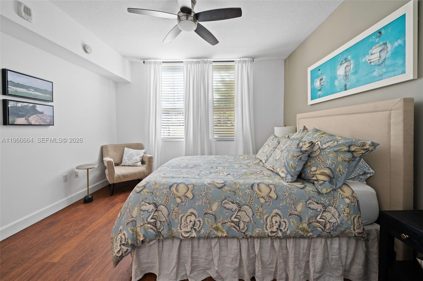 55 Merrick Way, Unit 507 Coral Gables, FL 33134 - Photo 13 of 28 a bedroom with a bed and wooden floor