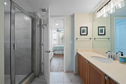 a en suite bathroom with a shower sink and mirror