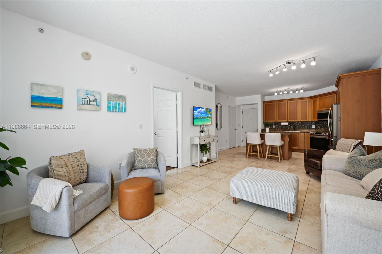 55 Merrick Way, Unit 507 Coral Gables, FL 33134 - Photo 2 of 28 a living room with furniture and a dining table