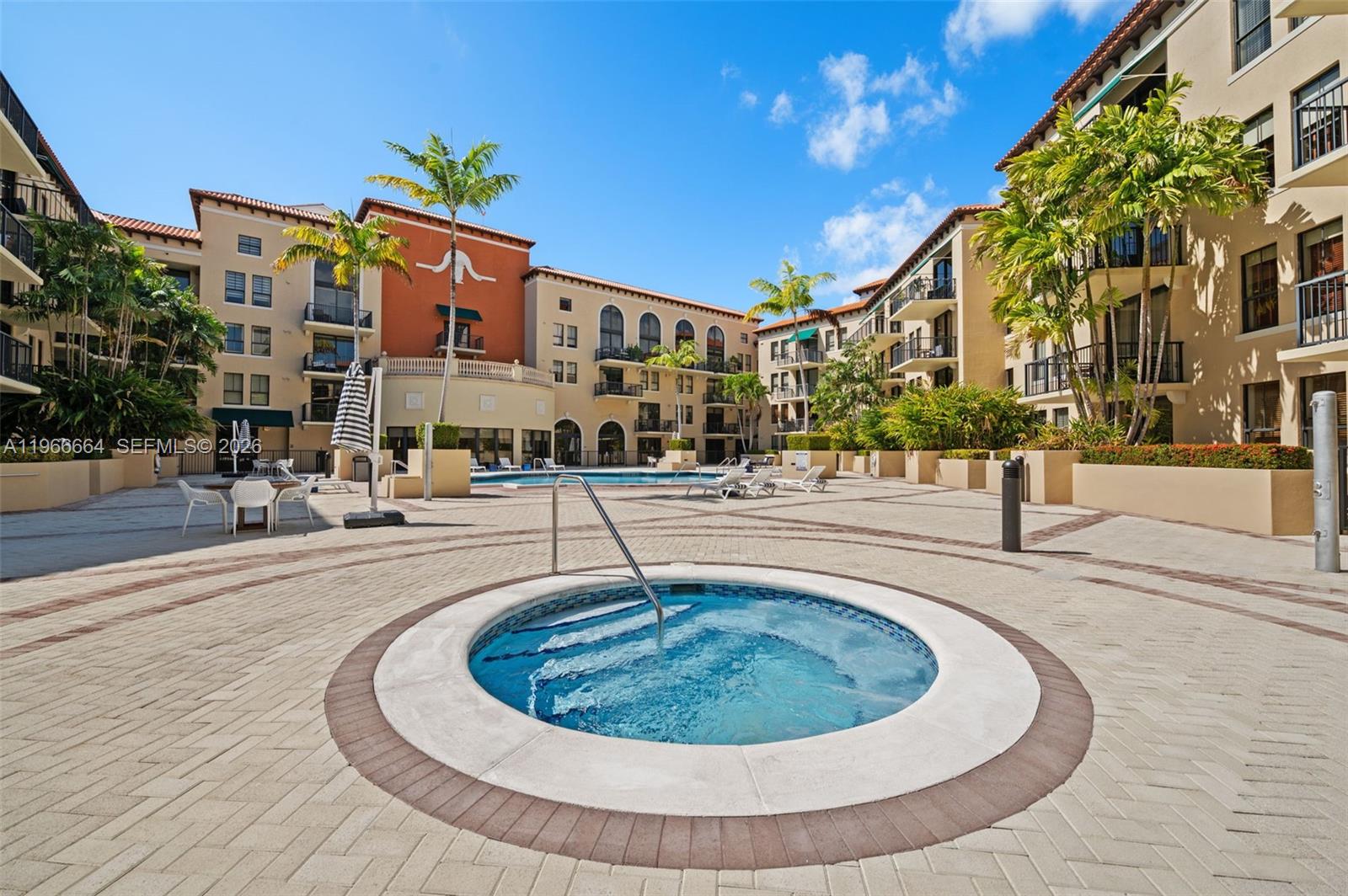55 Merrick Way, Unit 507 Coral Gables, FL 33134 - Photo 25 of 28 a swimming pool with outdoor seating and yard