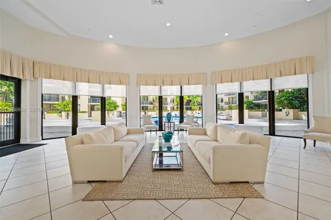 a living room with furniture and large windows