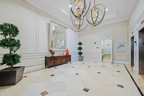 a spacious bathroom with a potted plant a sink and a mirror
