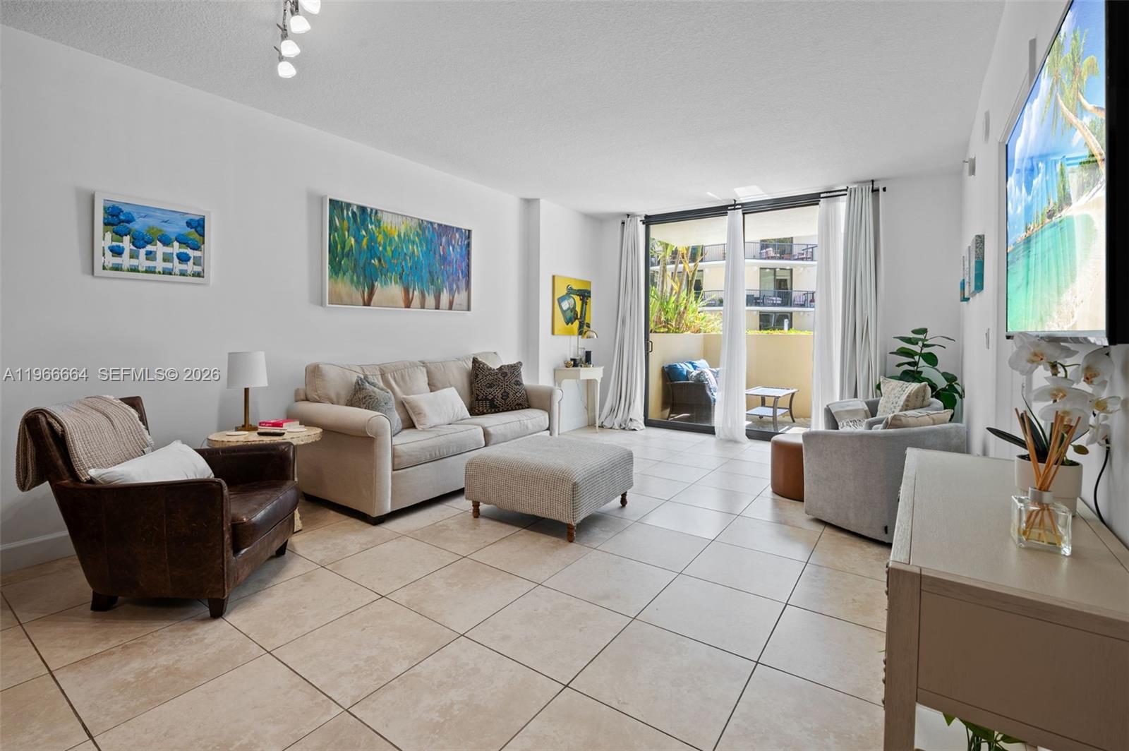 55 Merrick Way, Unit 507 Coral Gables, FL 33134 - Photo 4 of 28 a living room with furniture and a large window