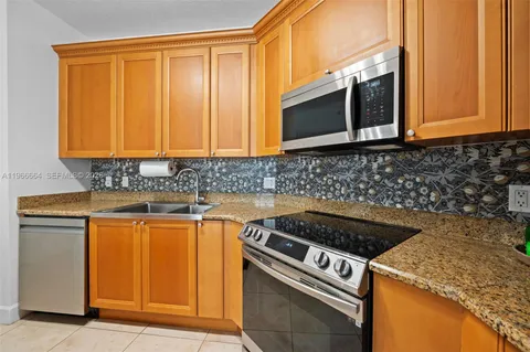 a kitchen with granite countertop cabinets and steel stainless steel appliances