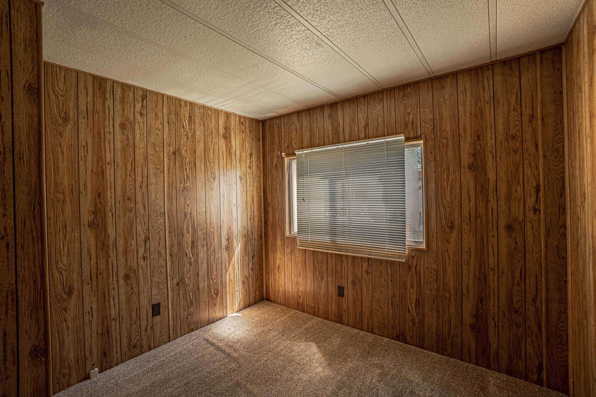 421 Stevens Road, Unit 26 Eagle Point, OR 97524 - Photo 16 of 23 a view of an empty room with wooden door